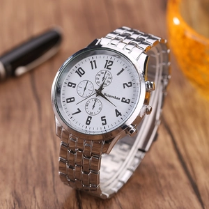 Detailed macro view of white dial quartz watch with numeral markers on wood surface