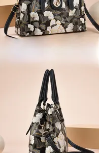 Dettagli di una borsa a tracolla da donna con ricamo floreale e chiusura in metallo dorato