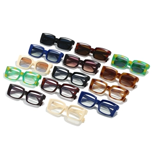 Flat lay of colorful vintage rectangle sunglasses and frames in a stylish array
