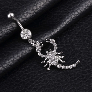 Silver scorpion belly button ring with sparkling rhinestones on black leather surface