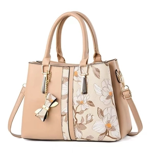 Elegant beige PU leather handbag with white floral magnolia print and golden hardware