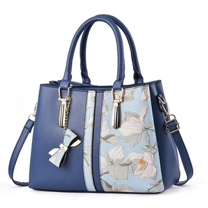 Elegant navy blue handbag with floral embroidery and gold accents for women
