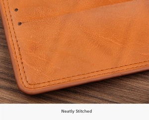 Close-up of the neat stitching and rounded edges on the brown leather wallet