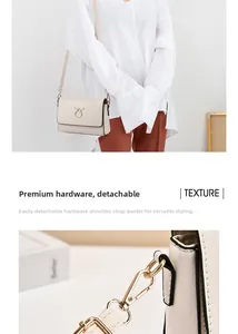 Detail of detachable gold lobster clasp and textured cream faux leather crossbody bag