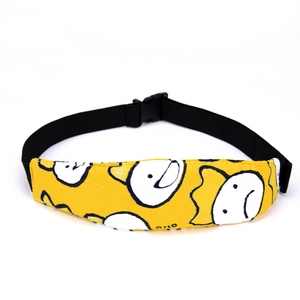 Detail of yellow cartoon head support strap with adjustable black buckle for baby stroller