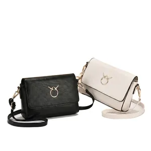Detailed macro view of the golden deer horn metal buckle and fine leather texture on bag