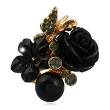 Macro view of vintage flower ring featuring black rose, pearl, and grey rhinestones