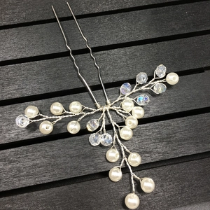 Detail of silver bridal hair pin with white pearls and sparkling crystal beads decoration