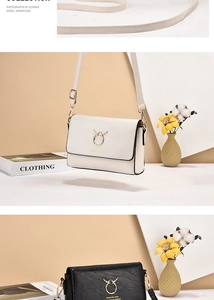 Detailed macro view of minimalist leather crossbody bags with golden antler metal buckle