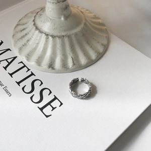 Macro detail of silver woven texture and adjustable open band on a vintage style ring