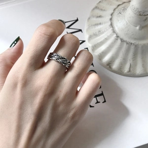 Macro detail of retro woven silver ring showing intricate vintage metal texture