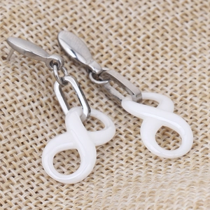 Fashionable silver stainless steel earrings with white infinity symbol ceramic pendants
