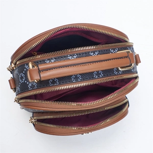 Top view of a three-layered zip crossbody bag showing ample interior storage space