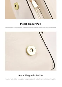 Detail of premium golden metal zipper and magnetic snap on white leather bag