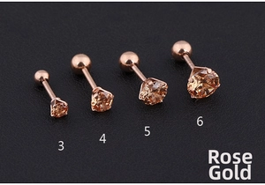 Detailed view of four rose gold titanium steel stud earrings with champagne cubic zirconia