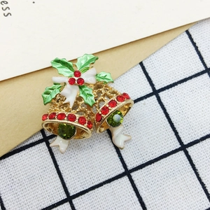 Golden Christmas bell brooch with green enamel leaves and sparkling red rhinestones