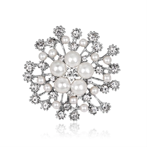 Exquisite snowflake brooch with pearls and crystals on a clean white background