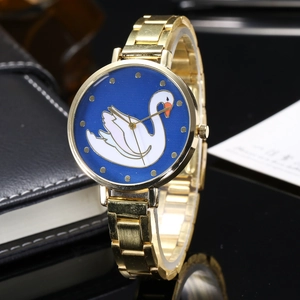 Close-up of golden watch face featuring a blue dial with an elegant swan motif