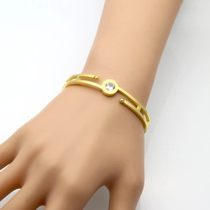 Fashionable gold-plated titanium steel hollow bangle featuring Roman numerals and zircon