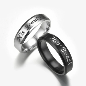 Detail view of stainless steel couple rings engraved with His Beauty and Her Beast
