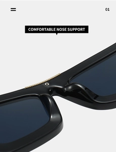 Detail of ergonomic integrated nose support and gold chain trim on black sunglasses