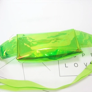 Close-up of vibrant neon green holographic PVC waist bag with adjustable strap