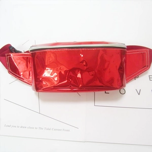Detail view of glossy red patent leather fanny pack with matching zipper and strap