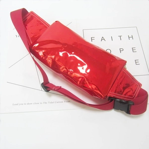 Detail of glossy red PVC waist bag featuring a high-shine finish and durable black buckle