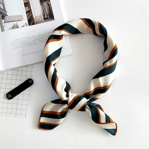 Linen texture striped scarf with green, brown and white patterns tied in a loose knot