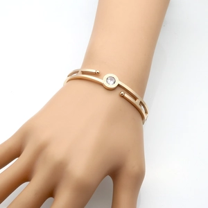 Rose gold Roman numeral hollow bangle with center zircon crystal on female wrist