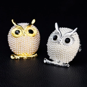 Elegant owl-shaped brooches in gold and silver finish with white pearls and black stones