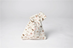 Detail of canvas wrist bag featuring colorful cat print and a Japanese knot closure