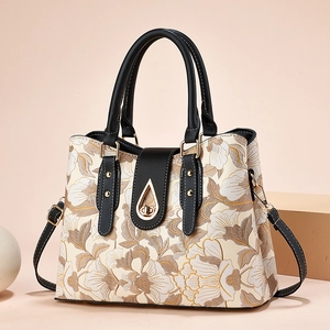 Borsa a mano floreale con dettagli in pelle marrone e chiusura dorata su supporti geometrici