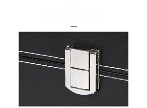 Close-up of premium black leather jewelry box with silver hardware and white stitching