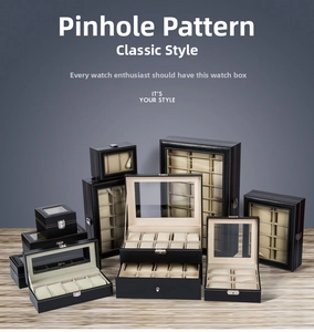Detail view of black pinhole leather watch boxes with transparent lids and soft beige cushions
