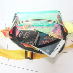 Detailed view of iridescent holographic waist bag with yellow strap and inner storage space