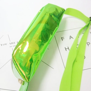 Close-up of holographic green PVC waist bag featuring reflective finish and nylon strap