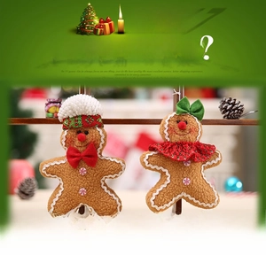 Detail of plush gingerbread man hanging ornaments with festive bows and striped hats