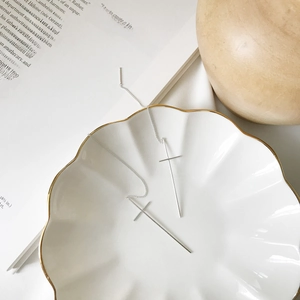 Minimalist S925 sterling silver cross threader earrings on a decorative shell plate