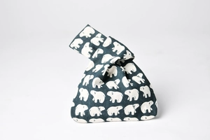 Close-up of Japanese knot bag featuring white polar bear prints on navy cotton fabric