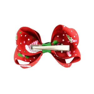 Christmas themed baby hair bow with festive candy cane prints and green ribbon center
