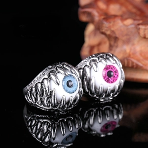 Macro view of Gothic punk claw rings holding blue and pink resin devil eyes