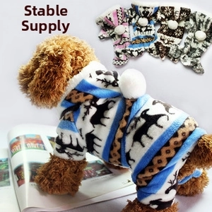 Detail of warm flannel pet jumpsuit with reindeer pattern and fuzzy pompom hood