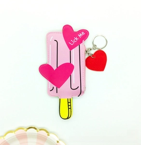 Detail of popsicle coin purse showing pink PU leather finish and heart Lick Me charm
