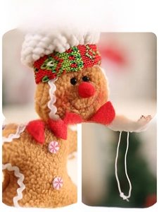 Detailed view of plush gingerbread man ornament with festive red bow and white hat