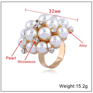 Adjustable cluster cocktail ring with pearls and rhinestones on a white background