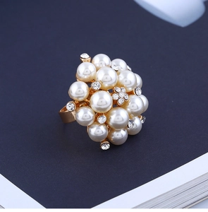 Detailed view of adjustable gold alloy ring with clustered pearls and crystal accents