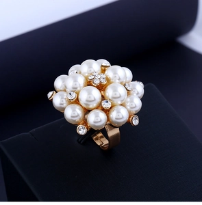 Detailed macro view of vintage gold ring with white pearls and sparkling rhinestones