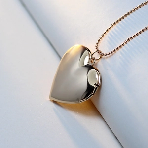 Polished gold heart locket pendant with rose relief and elegant bead chain detail