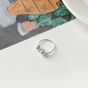 Top-down view of a minimalist S925 silver open ring with dual polished round beads